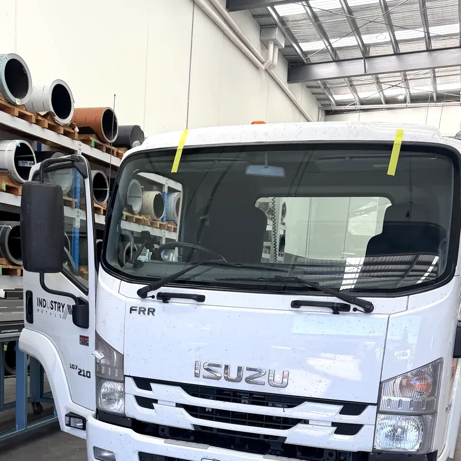 Isuzu truck with a newly fitted windscreen held in place while the bond sets